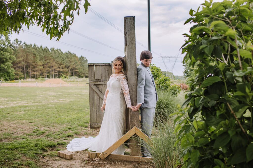 Elegant event setting with decorated tables, featuring floral centerpieces and soft lighting in a rustic venue. Suitable for gatherings or celebrations.