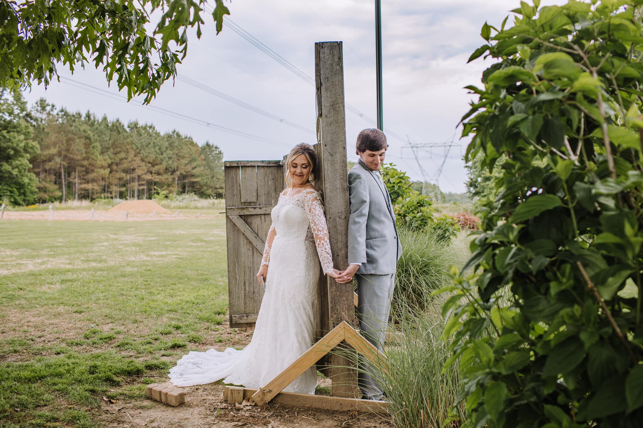 Elegant event setting with decorated tables, featuring floral centerpieces and soft lighting in a rustic venue. Suitable for gatherings or celebrations.